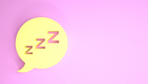 A yellow speech bubble with three Z letters inside, symbolizing sleep, on a pink background.