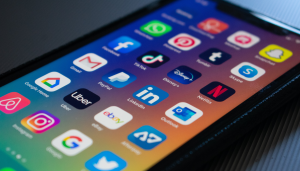 A smartphone screen displaying various app icons, including Facebook, WhatsApp, Instagram, TikTok, Gmail, PayPal, Disney+, Netflix, LinkedIn, Uber, eBay, Outlook, and Google Maps.